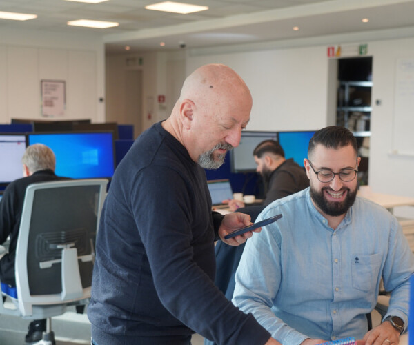 Two people coworking and smiling together in an office setting.
